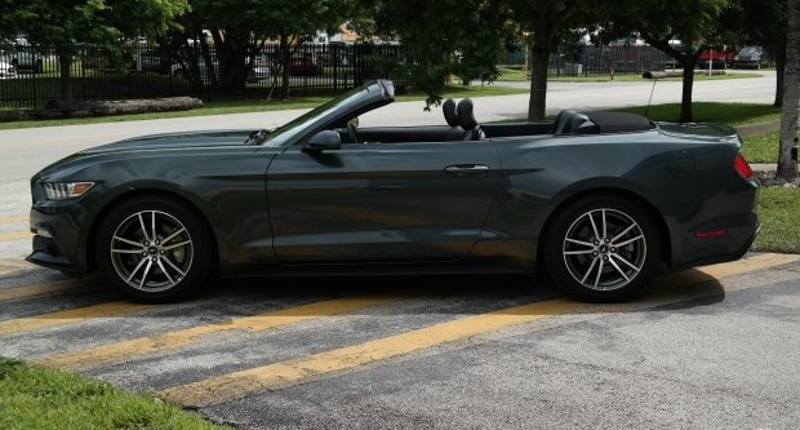 left side view of a 2016 Guard gray/green Mustang convertible
